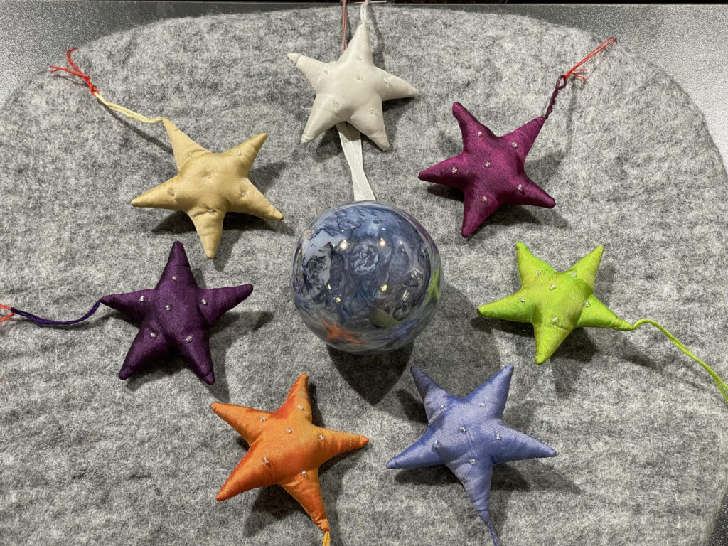 Mundgeblasene Glaskugel mit verschiedenfarbigen Stoffsternen